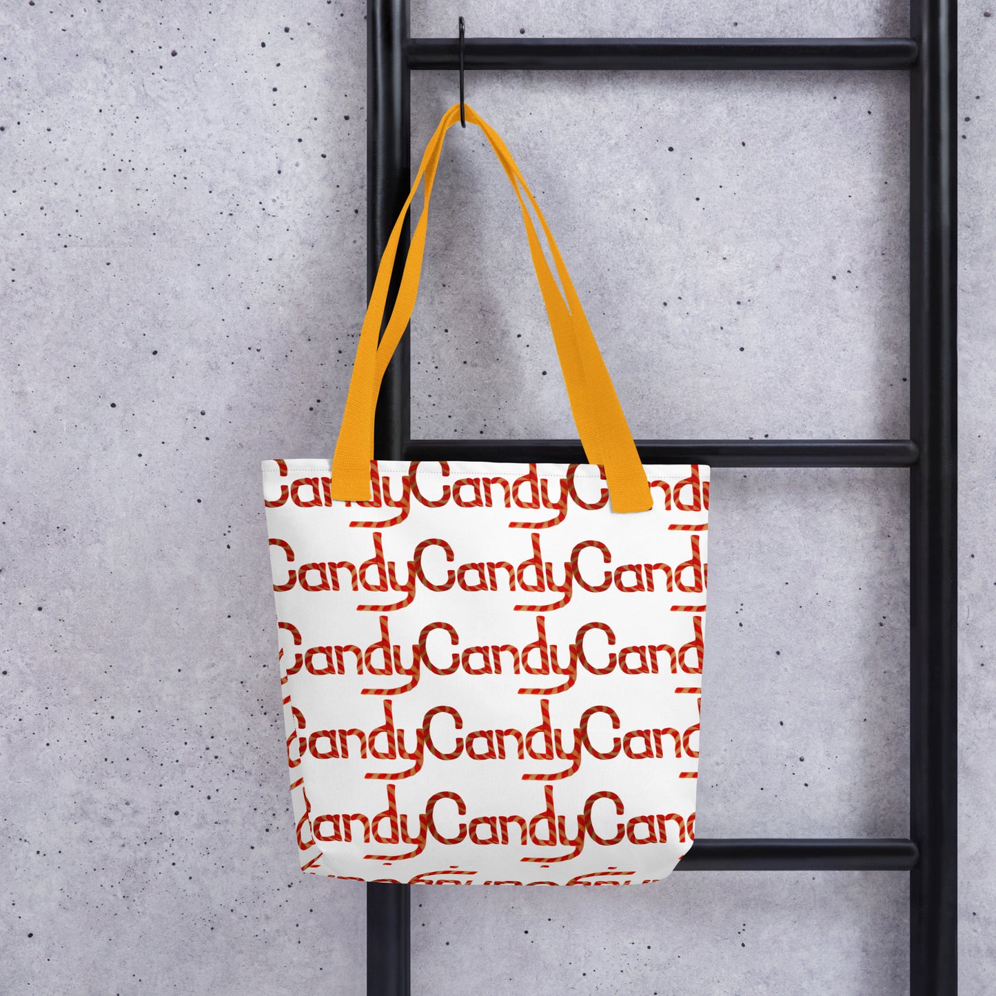 Candy cane print tote bag CHRISTMAS AND HALLOWEEN with orange handles hanging on black ladder