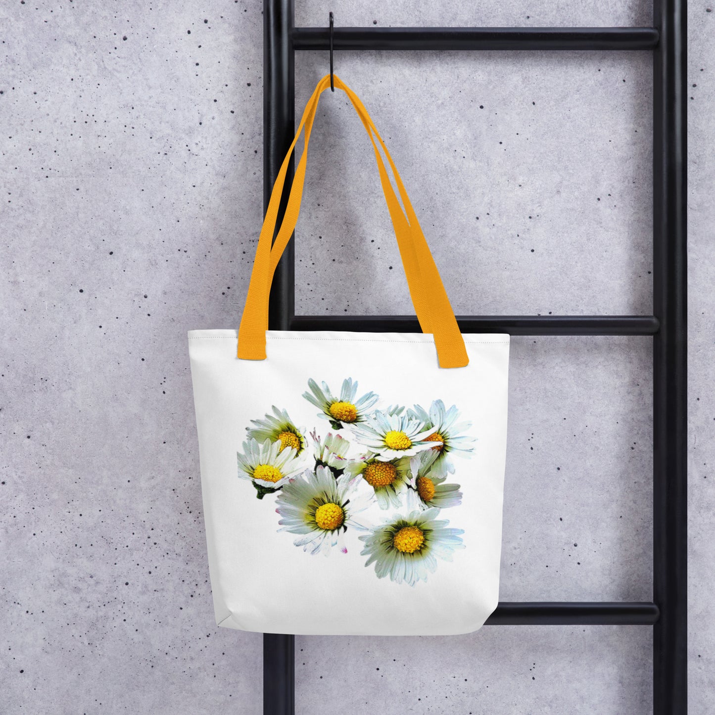White daisy print shopping bag with yellow handles hanging on black ladder