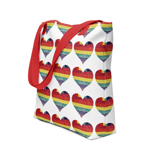 LGBT pride tote bag with red handles and rainbow heart pattern on a white background