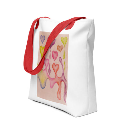 White tote bag with red straps featuring an artistic heart print tote bag design in colorful pastel shades