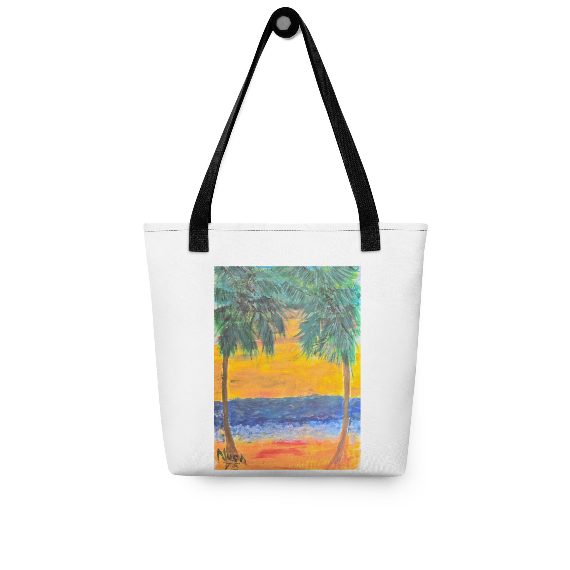White beach tote bag with palm tree design featuring a sunset and ocean scene with black handles