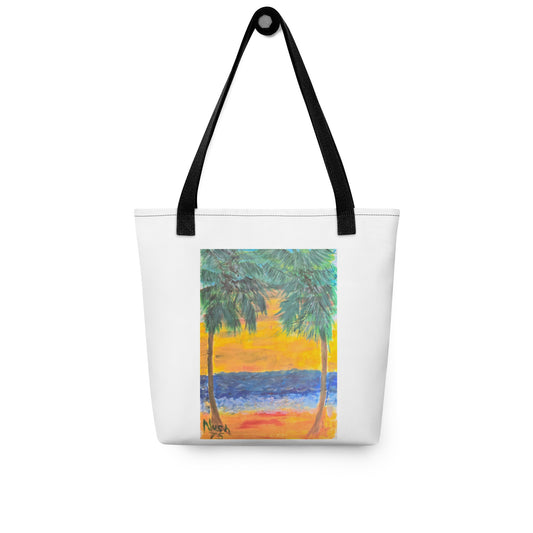 White beach tote bag with palm tree design featuring a sunset and ocean scene with black handles