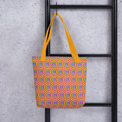 Colorful boho tote bag for summer with orange handles hanging on black ladder against concrete wall