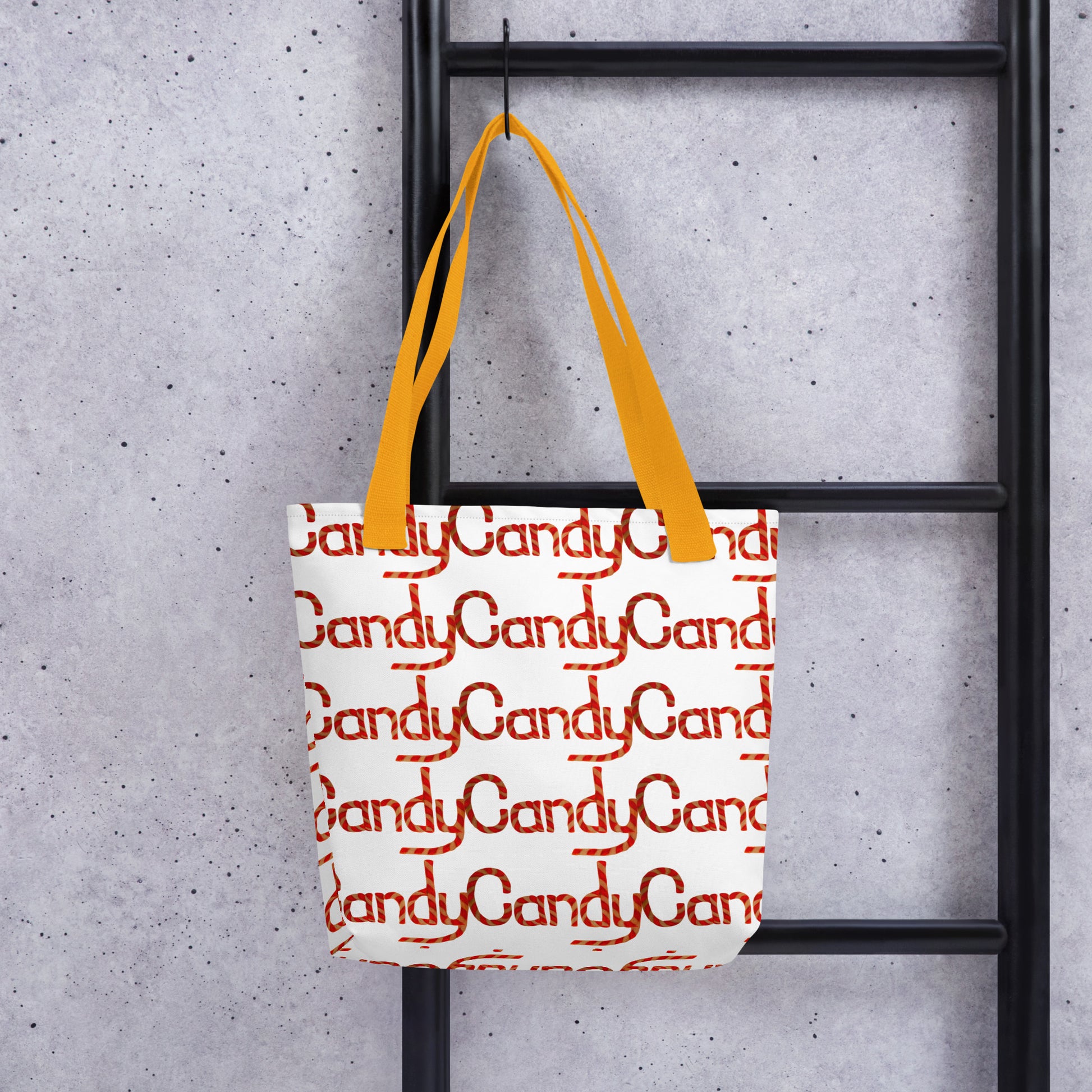 Candy cane print tote bag CHRISTMAS AND HALLOWEEN with orange handles hanging on black ladder