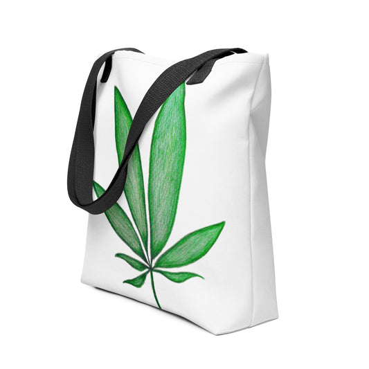 White canvas shopping tote with leaf design featuring green leaf print and black handles