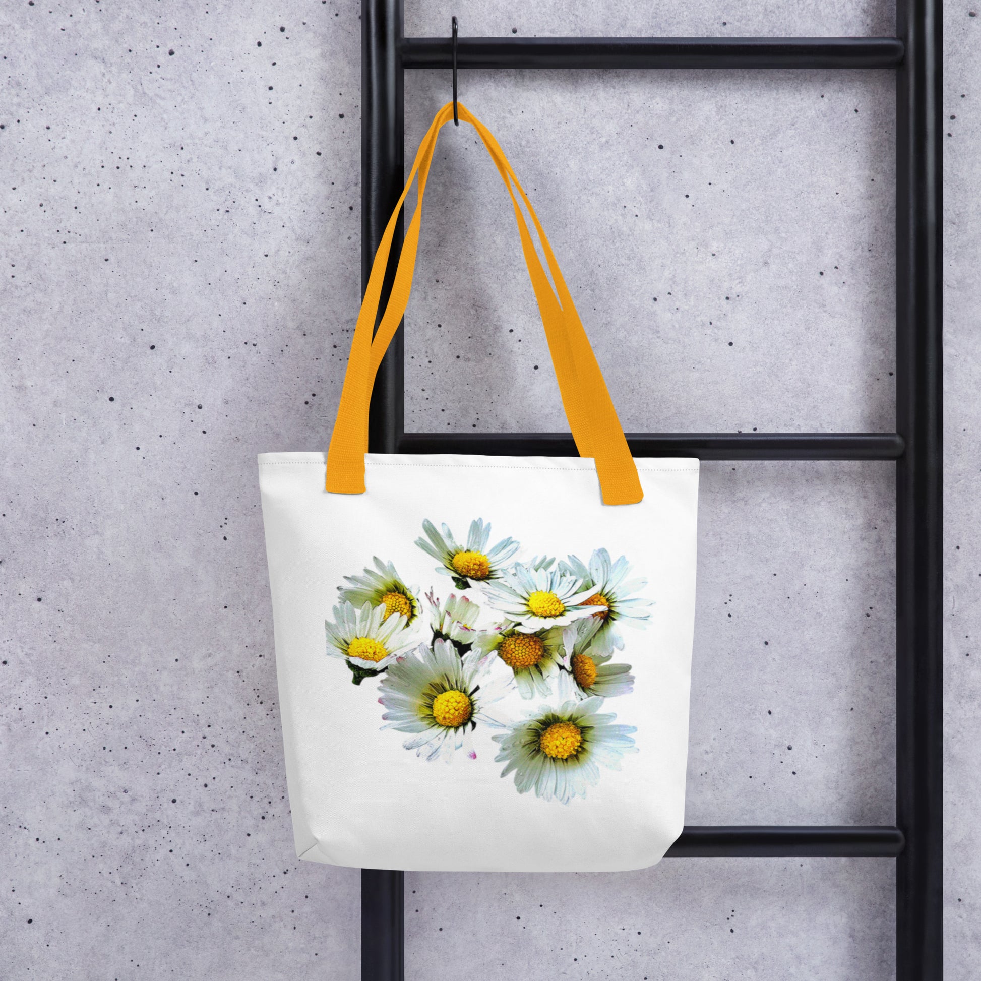 White daisy print shopping bag with yellow handles hanging on black ladder