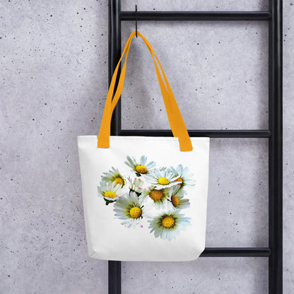 White daisy print shopping bag with yellow handles hanging on black ladder