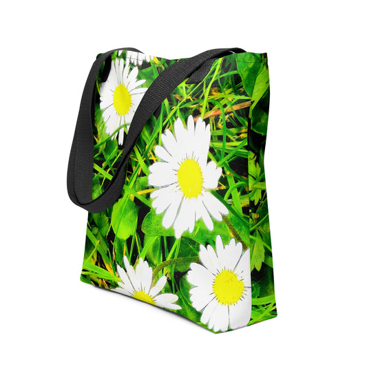 Daisy print tote bag with white daisies and green grass background featuring black shoulder straps