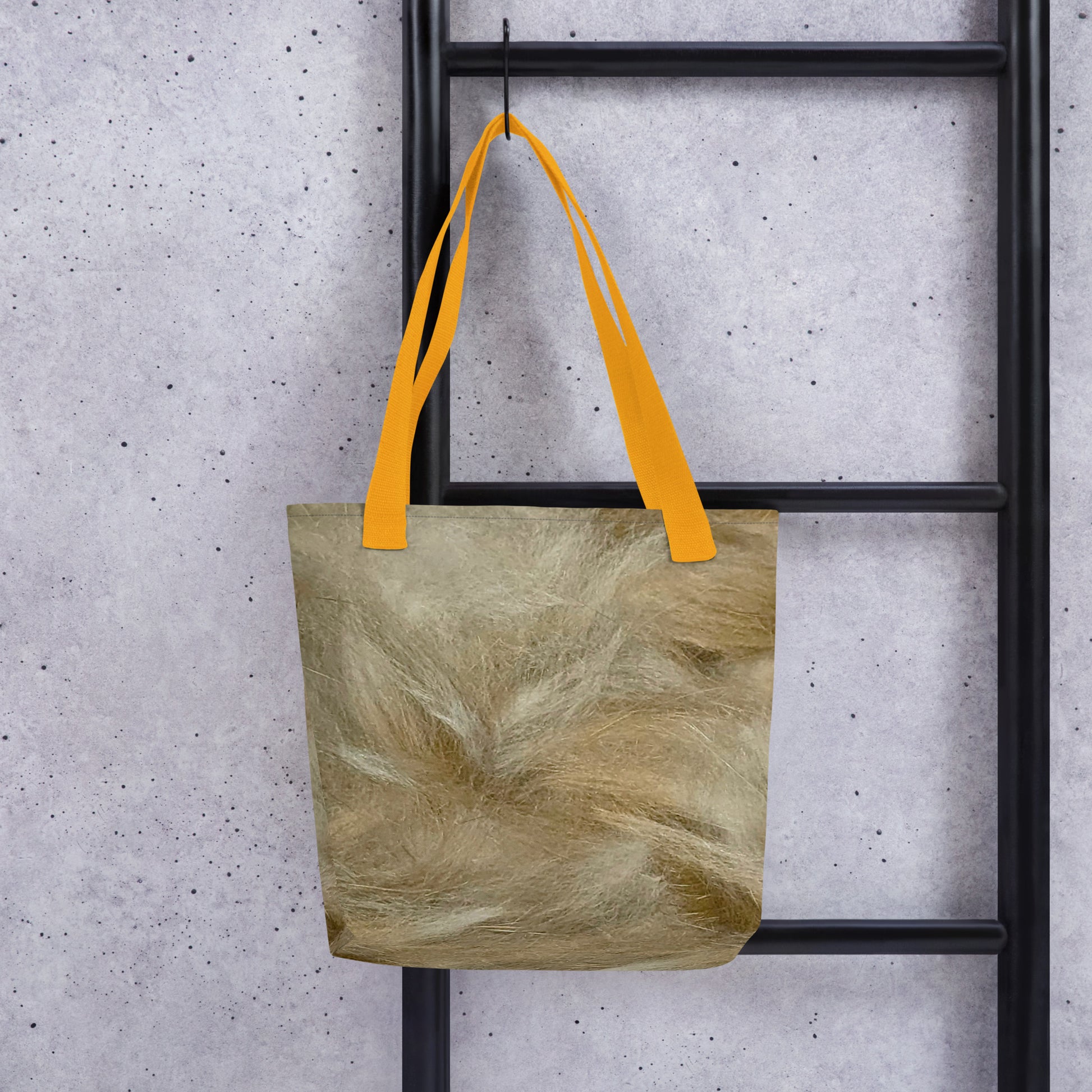 Durable canvas shopping tote with textured beige fabric and bright orange handles hanging on black ladder
