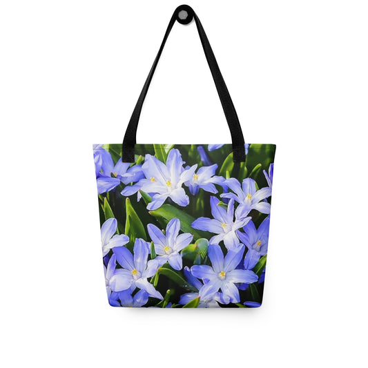 Large floral print tote bag featuring vibrant purple and white flowers with green leaves and black straps