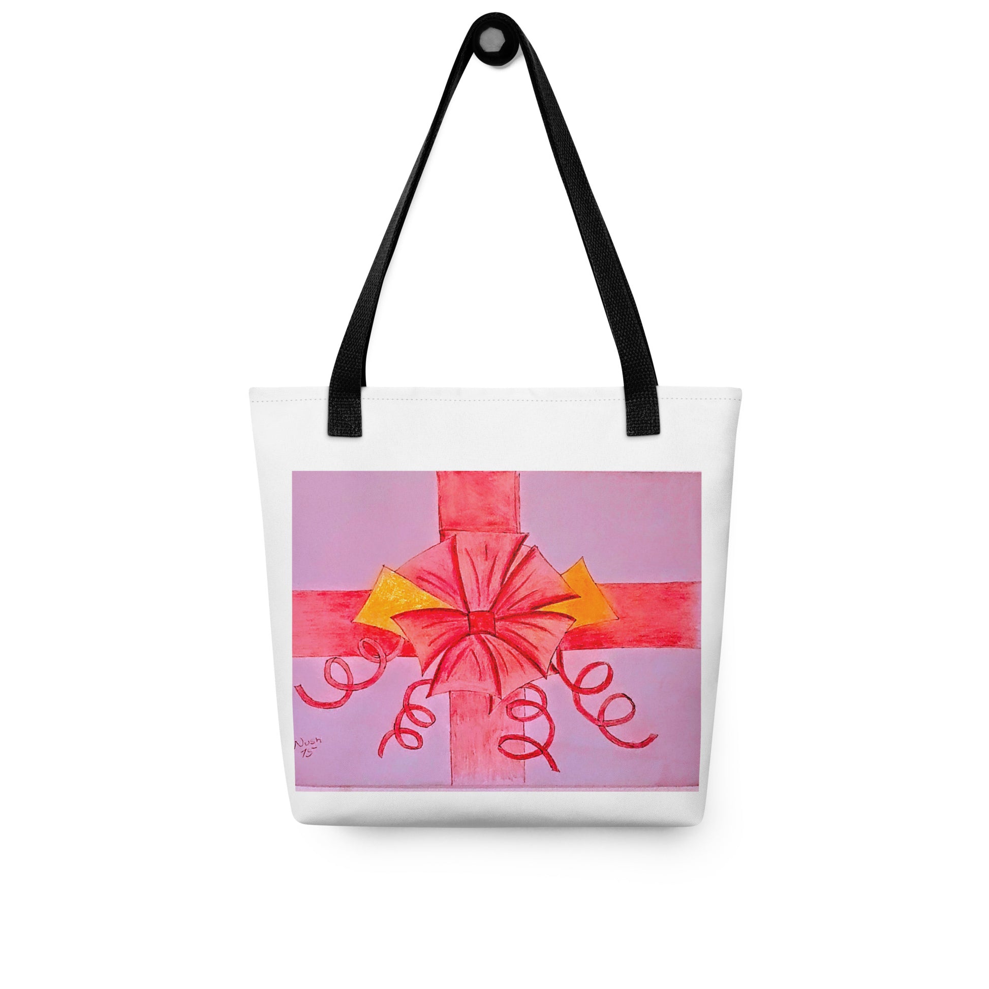 White tote bag with black straps featuring a pink ribbon gift tote design with red and yellow bow accents