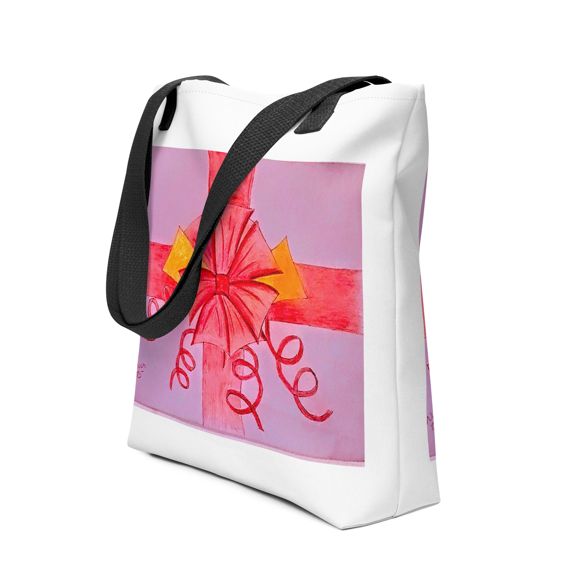 White tote bag with black straps featuring a pink ribbon gift tote design with decorative bow and curly ribbons