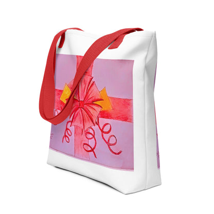 White tote bag with red handles featuring a pink ribbon gift tote design from NUSH'S STORE