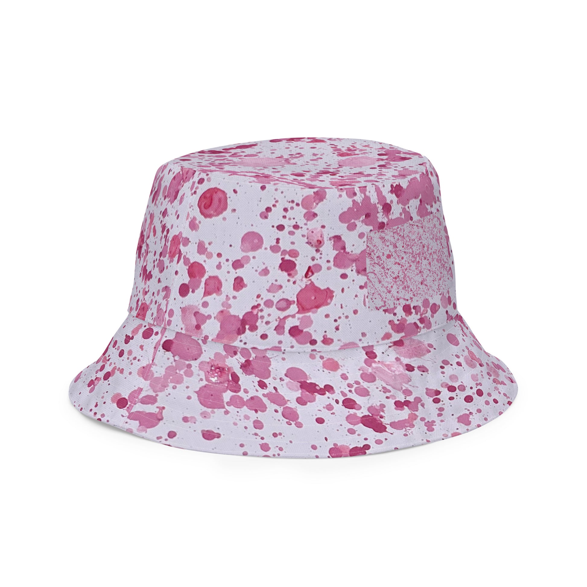 Pink splatter bucket hat from NUSH'S STORE with vibrant paint splatter design for festival wear