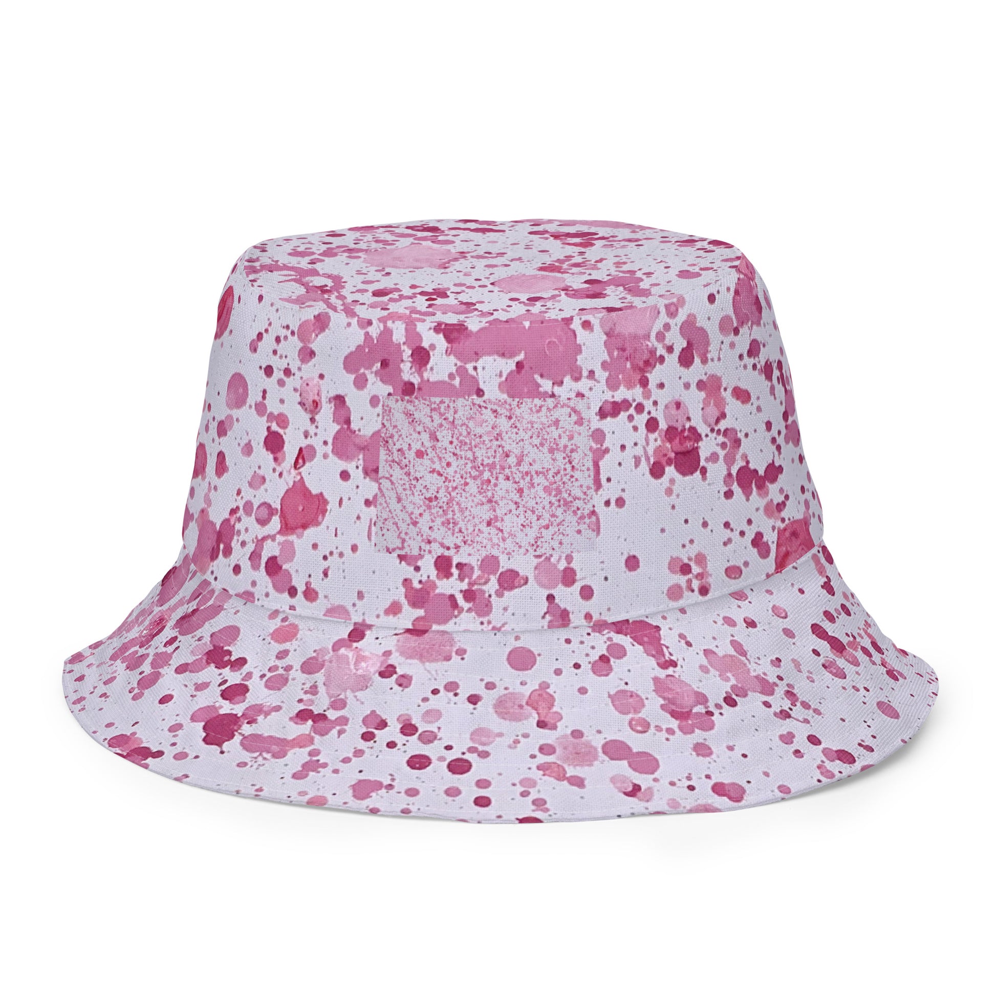 Pink splatter bucket hat from NUSH'S STORE with a white base and vibrant pink paint splatter design