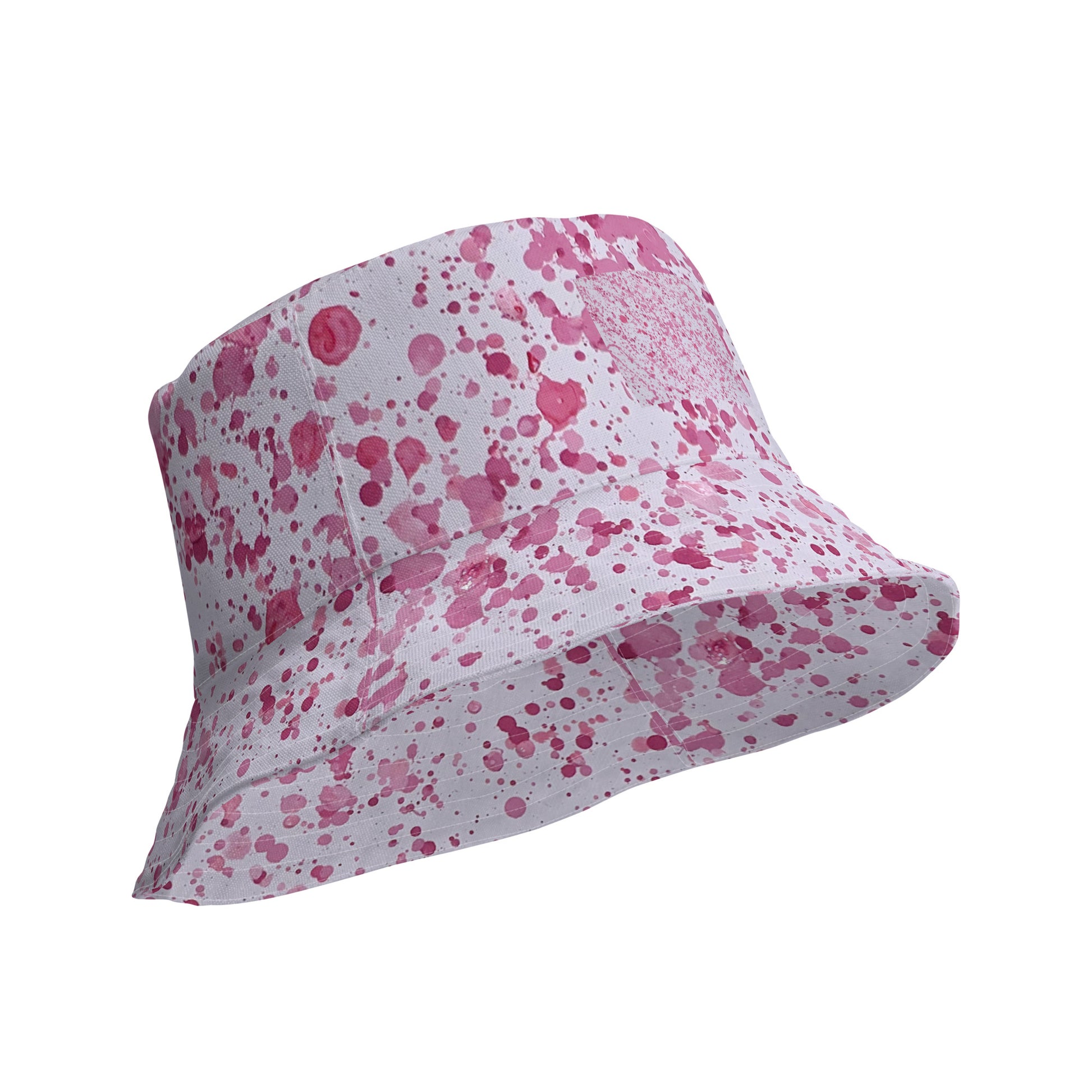 Pink splatter bucket hat from NUSH'S STORE with a white base and pink paint splatter design