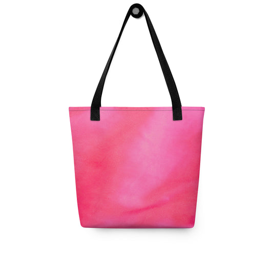 Pink tote bag for women with black shoulder straps hanging against white background