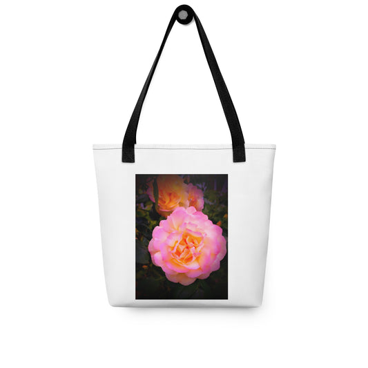 White shoulder bag with pretty flower design shoulder bag featuring a pink and orange rose print and black straps