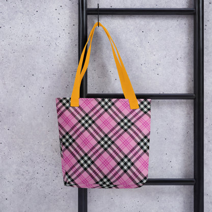 Pink and black trendy checkered tote purse with bright yellow straps hanging on black ladder