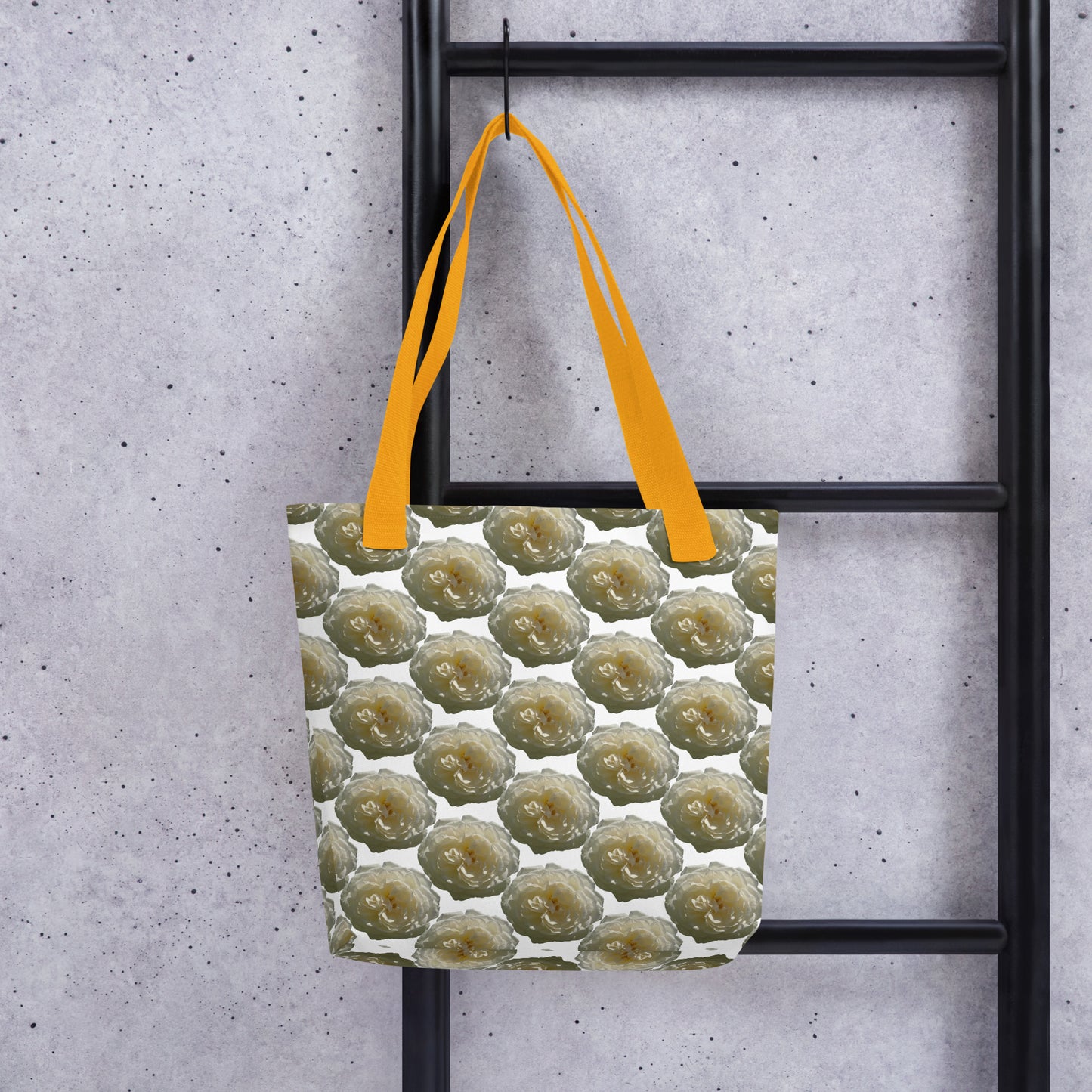 Eco-friendly shopping tote A WHITE ROSE PRINT with yellow handles hanging on black ladder