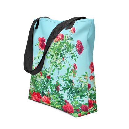 Blue tote bag with black straps featuring a VINTAGE ROSE PRINT of red roses and green leaves