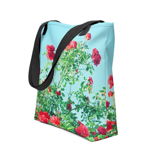 Blue tote bag with black straps featuring a VINTAGE ROSE PRINT of red roses and green leaves