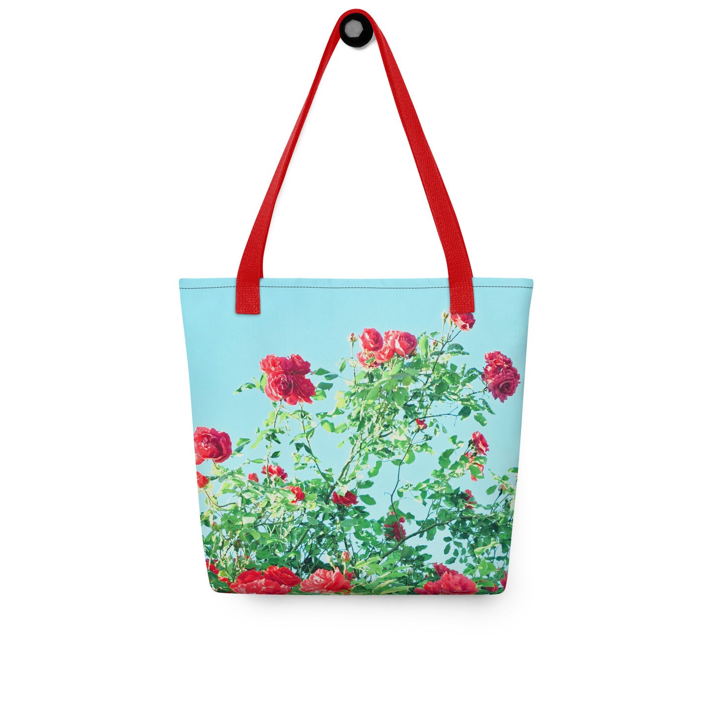 VINTAGE ROSE PRINT rose print beach tote with red handles and floral design on blue background