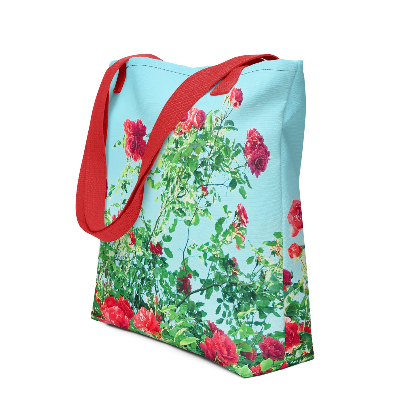 NUSH'S STORE tote bag with VINTAGE ROSE PRINT featuring red roses and green leaves on a blue background with red straps